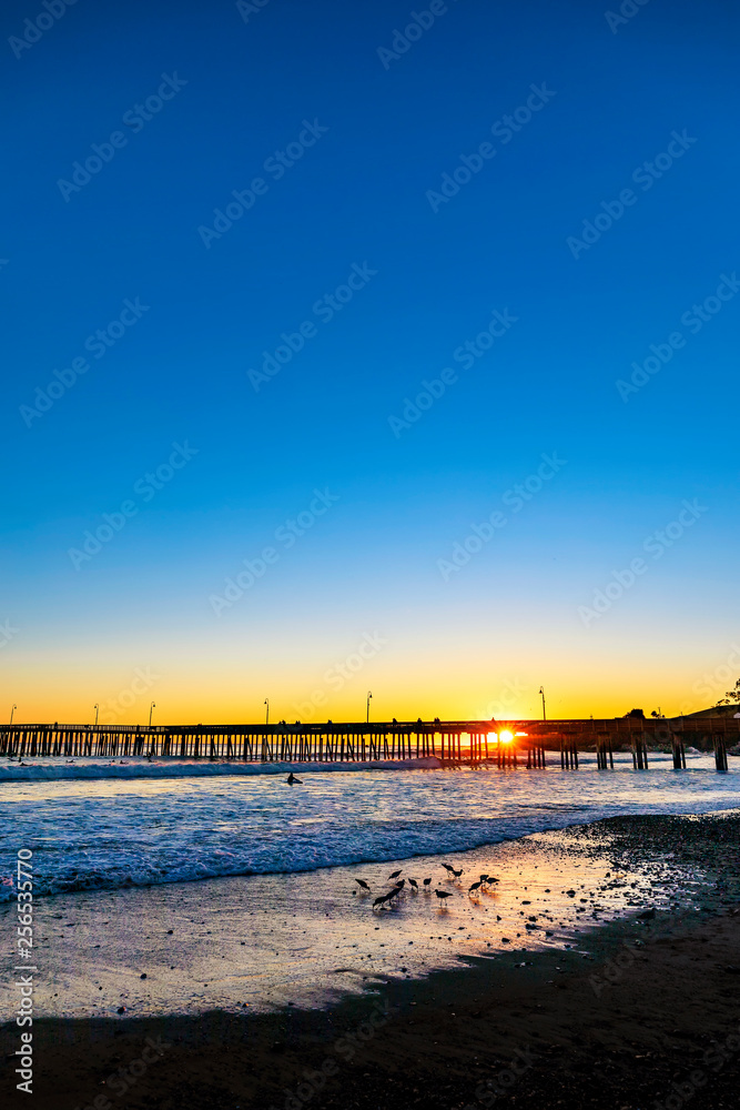 Silhouetted Pier at  beach at Sunset 