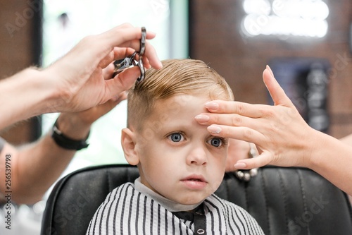 Baby in beauty salon for hair cutting