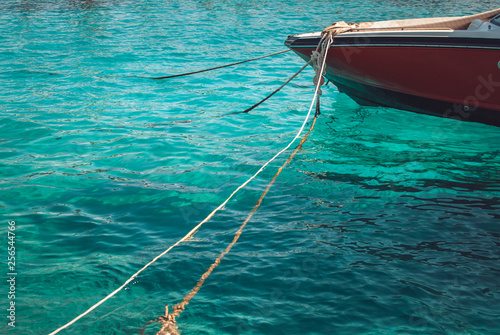 The fragment of elegant Red Luxury motor boat on the background of the azure blue sea © skrotov