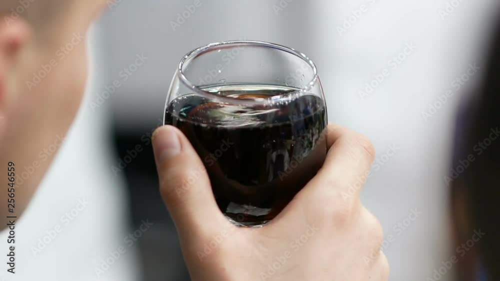 Man holding glass of cola at restaurant Man holding glass of cola at restaurant