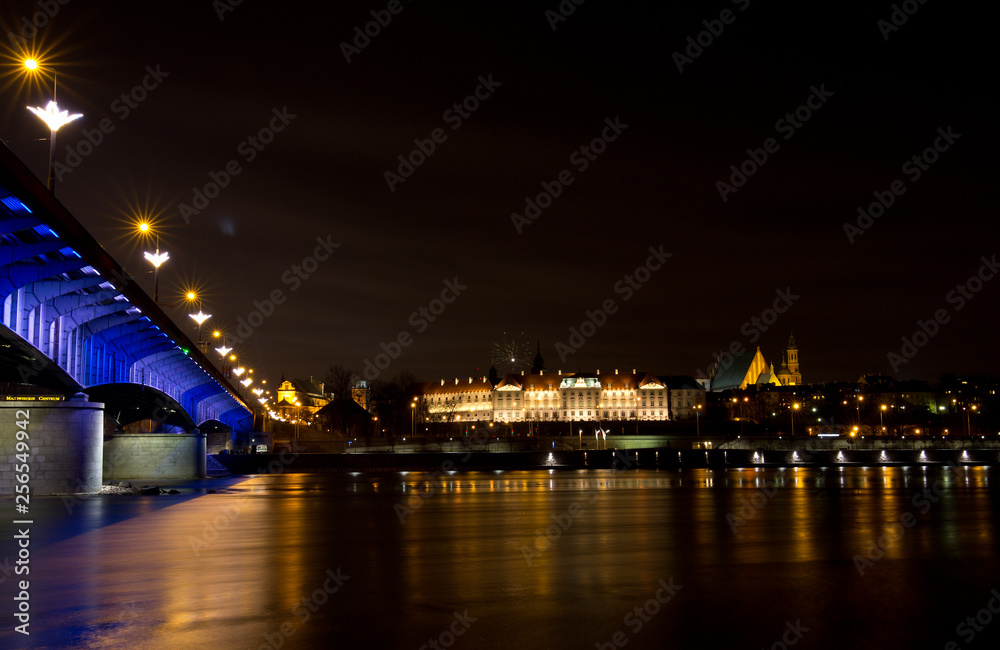 bridge at night, view of the river bridge and old town in Warsaw, Poland