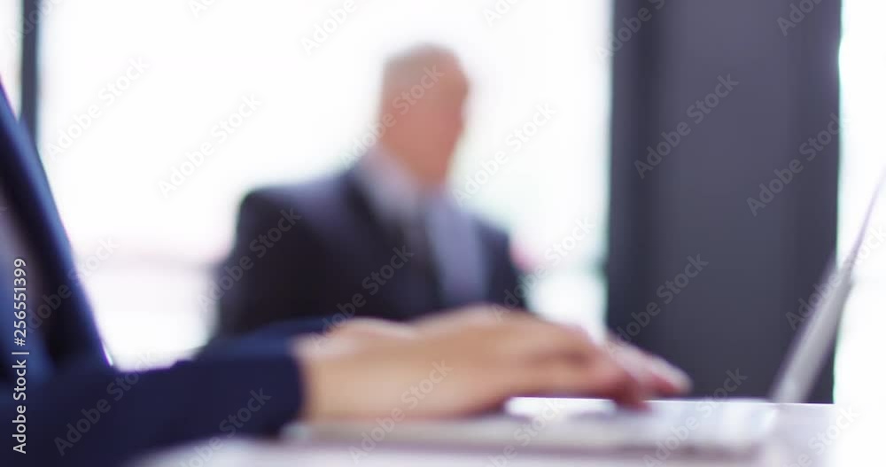4K Corporate business team in a bright sunlit office with focus pull. Slow motion. 4K Corporate business team in a bright sunlit office with focus pull. Slow motion.