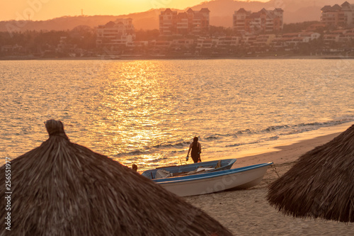 Mujer caminando al atardecer en playas de Bucerias, Mexico photo