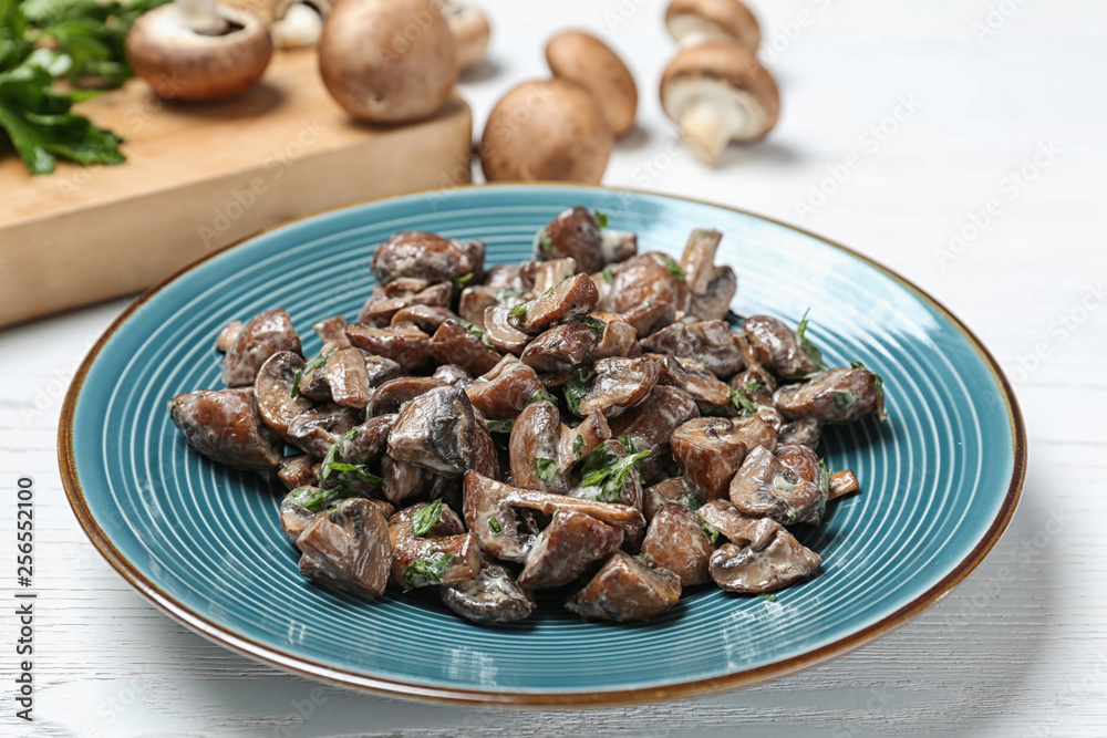 Plate of tasty fried mushrooms with sauce on table Plate of tasty fried mushrooms with sauce on table