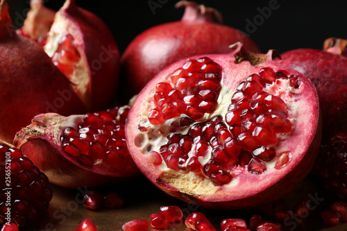 Delicious ripe pomegranates on table, closeup view