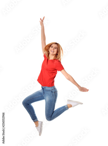 Fototapeta Naklejka Na Ścianę i Meble -  Full length portrait of happy beautiful woman jumping on white background