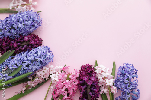 Frame made of spring hyacinth flowers on color background. Space for text
