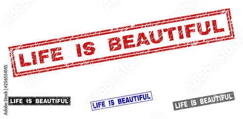 Grunge LIFE IS BEAUTIFUL rectangle stamp seals isolated on a white background. Rectangular seals with grunge texture in red, blue, black and gray colors.