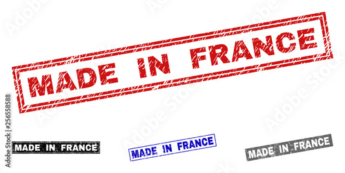 Grunge MADE IN FRANCE rectangle stamp seals isolated on a white background. Rectangular seals with distress texture in red, blue, black and grey colors.