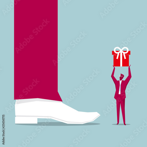  Businessman holds up a gift. In front of the huge legs. Isolated on blue background.