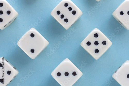 White gaming dices on light blue background. victory chance and lucky. Flat lay style  place for text. Top view and Close-up cube. Concept business  gamble and game. Spectacular background pastel.