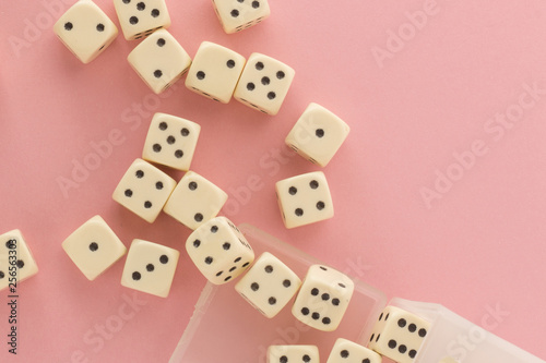 White gaming dices on pink background. victory chance and lucky. Flat lay style  place for text. Top view and Close-up cube. Concept business  gamble and game. Spectacular background pastel.