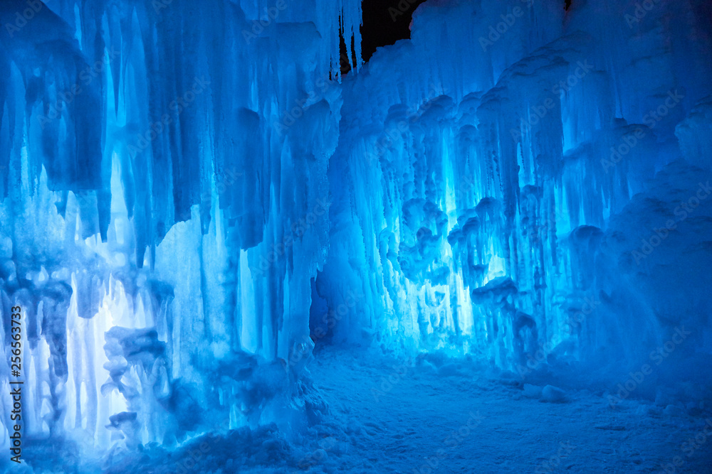 Wall Mural Wall of blue icicles on a subzero night after sunset on a lake in Minnesota USA