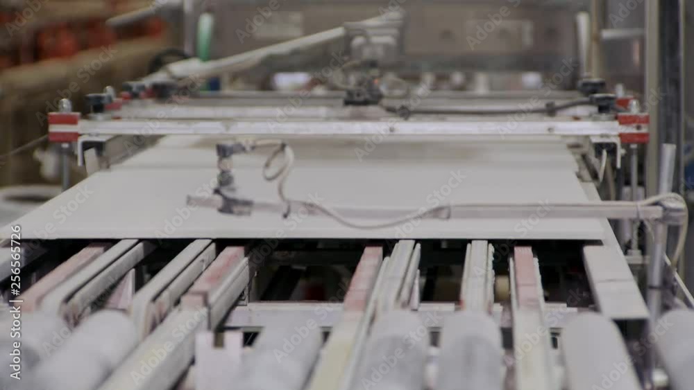 large ceramic plate blanks are moving between rollers inside machine, breaking at pieces large ceramic plate blanks are moving between rollers inside machine, breaking at pieces