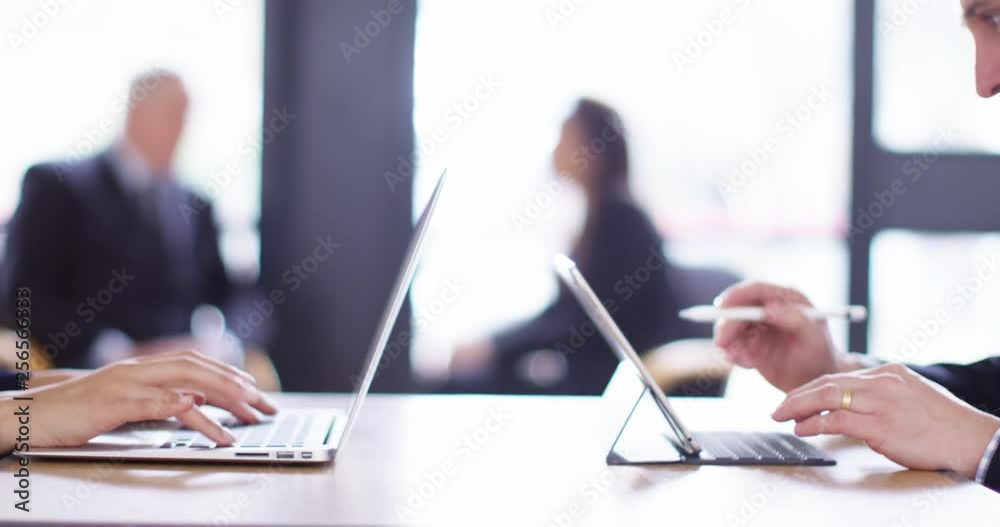 4K Business executives working opposite each other with colleagues blurred in background. Slow motion. 4K Business executives working opposite each other with colleagues blurred in background. Slow motion.