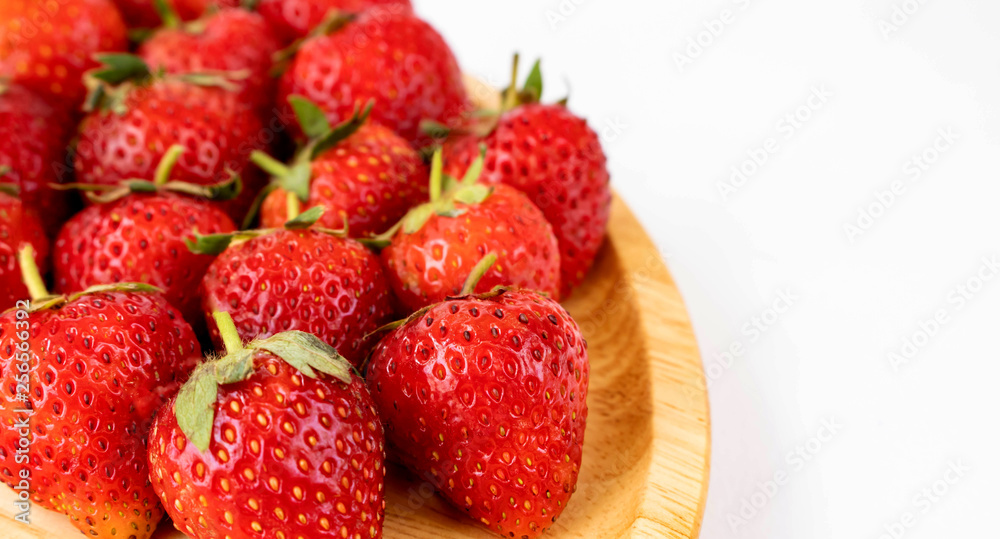 Strawberrys many with both ripe fruit and not fruit ripe in wooden tray Strawberrys and wooden tray all laid are on a white background. Strawberrys many with both ripe fruit and not fruit ripe in wooden tray Strawberrys and wooden tray all laid are on a white background.