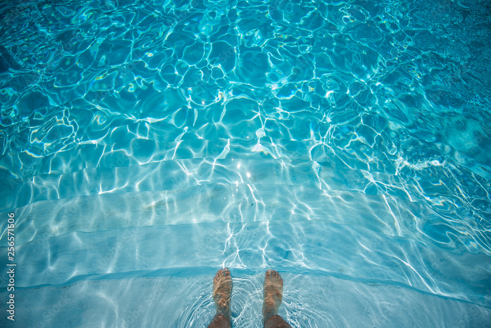 Male Feet Underwater in Swimming Pool