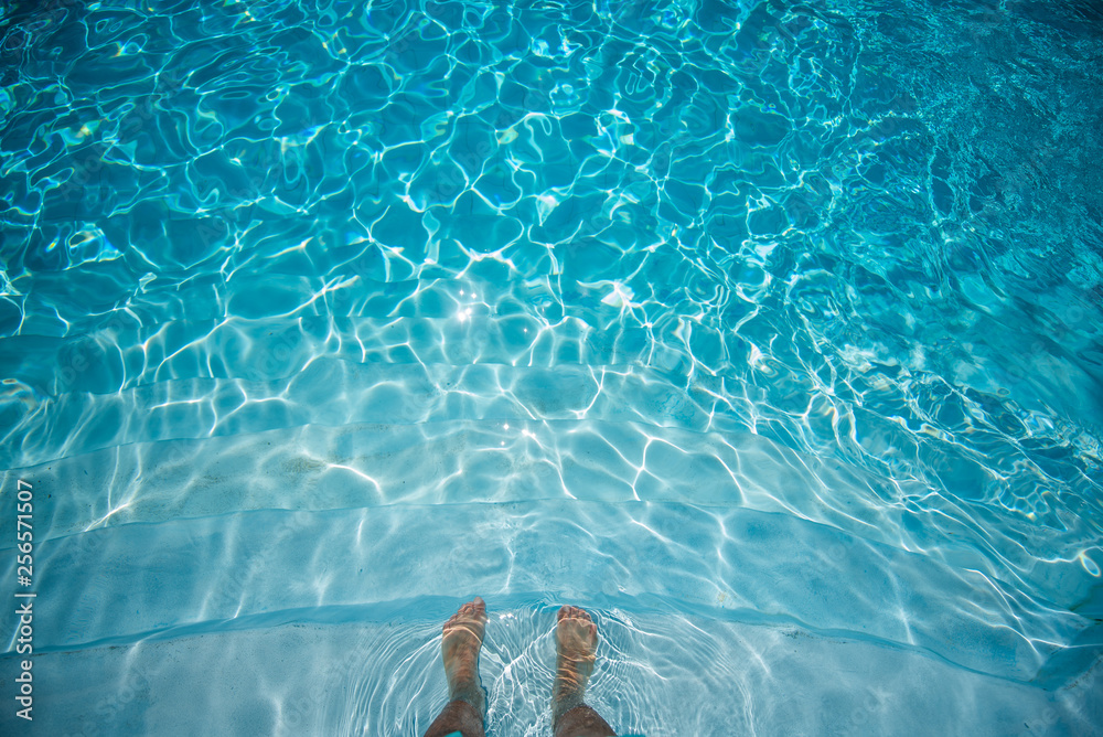 Male Feet Underwater in Swimming Pool