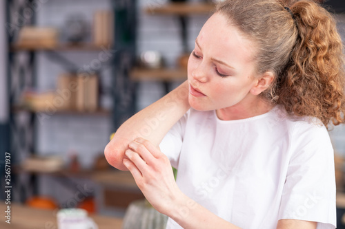 Fotografía Distressed unhappy young lady rubbing her spotted elbow