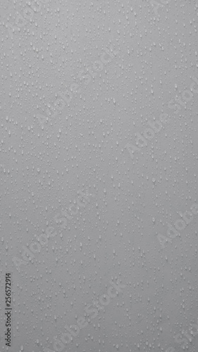 small water drops on gray or grey background, circle liquid shape in bathroom after take shower