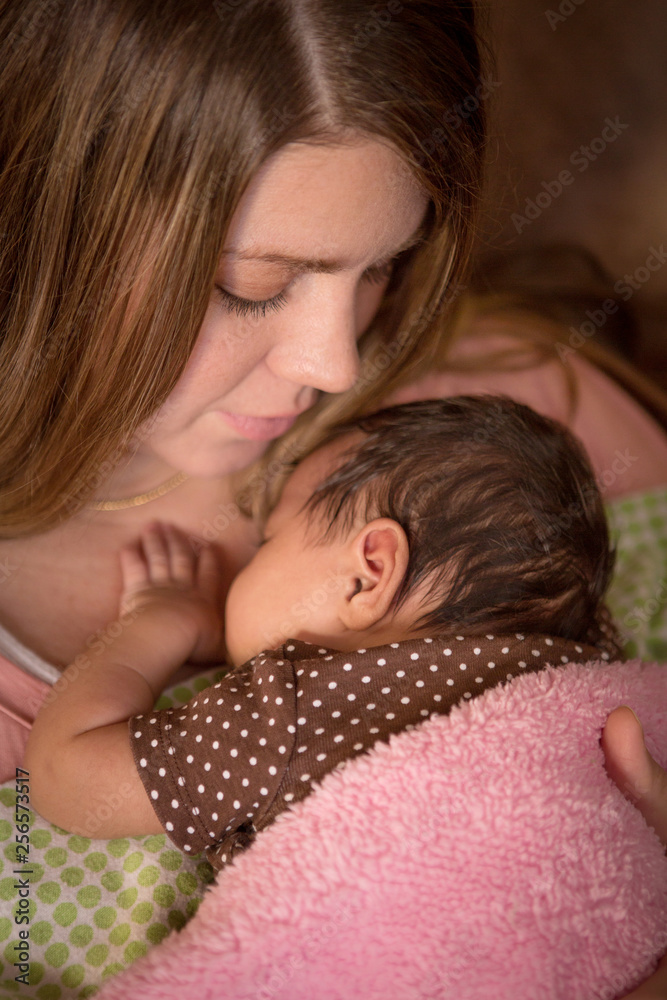 Portrait of a mother holding a new born baby. Portrait of a mother holding a new born baby.