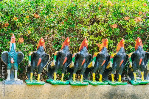 Colorful of many rooster statues at King Naresuan Monument in Kanchanaburi, Thailand.