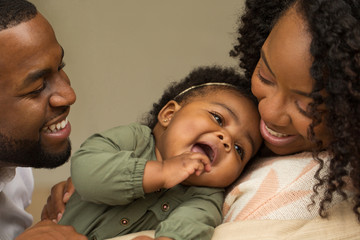 Happy African American family with their baby.