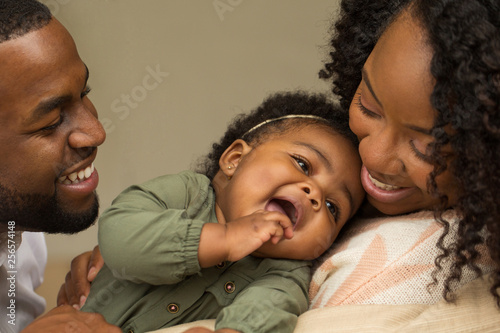 Happy African American family with their baby.