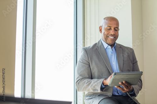 Mature African American man working on a tablet. photo