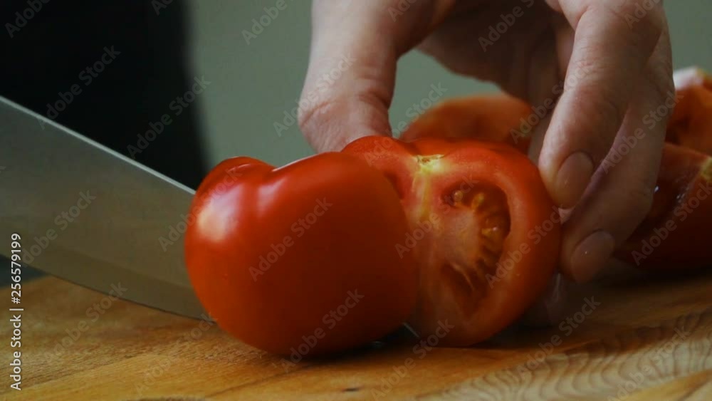 Cutting tomato by culinary knife. Slow motion Cutting tomato by culinary knife. Slow motion