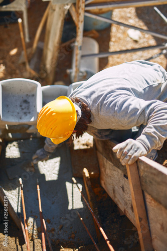 Construction worker on a heavy site doing hard work. © astrosystem