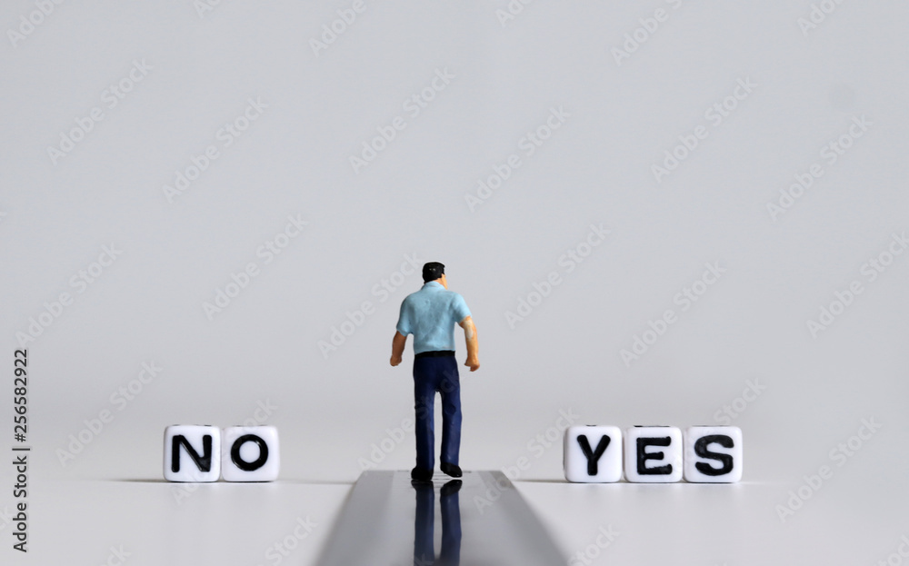 YES and NO text alphabet white cube. Miniature people. YES and NO text alphabet white cube. Miniature people.