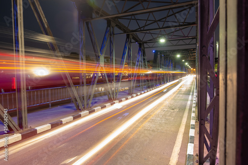 motion of head light of the car that drive pass iron bridge in night time