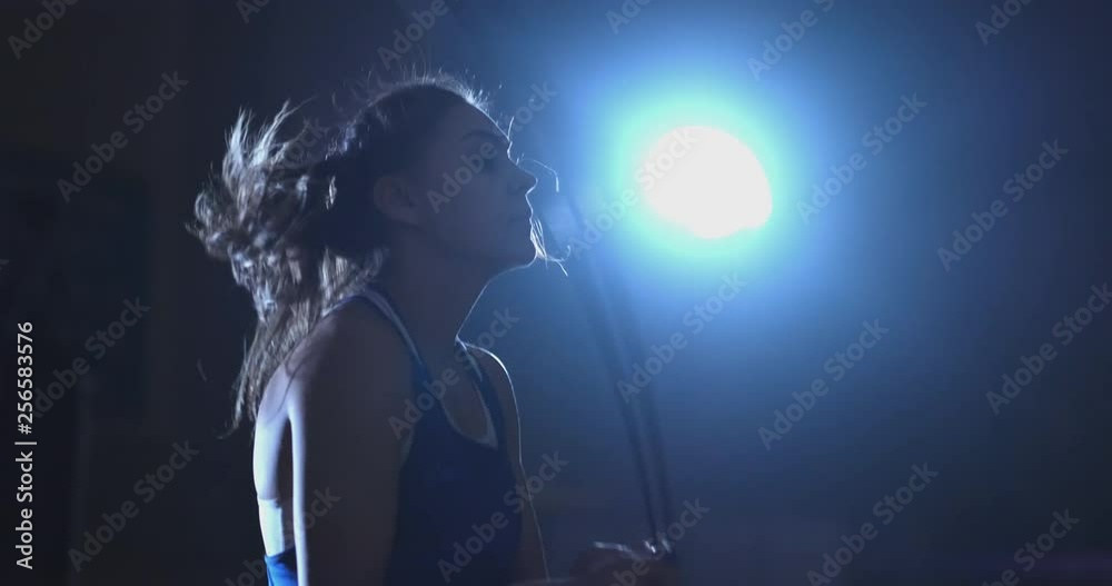Beautiful female boxer jumping rope during active Boxing training Beautiful female boxer jumping rope during active Boxing training
