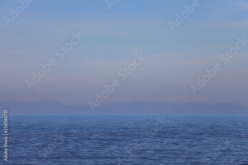 Simple seascape of hazy mountains on the horizon © Sy Finch