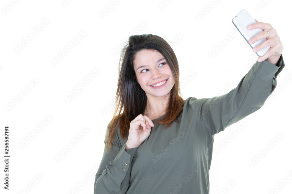 Portrait of a young attractive woman making selfie photo with smartphone on white background Portrait of a young attractive woman making selfie photo with smartphone on white background
