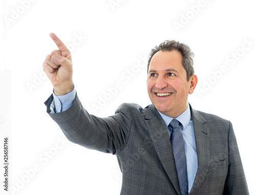 Portrait of a middle aged confident businessman pointing at copy space. Isolated on white.