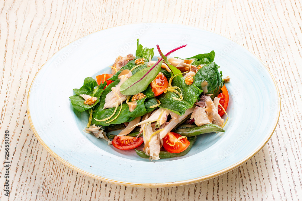 Mix salad with chicken and tomatoes. On light background Mix salad with chicken and tomatoes. On light background
