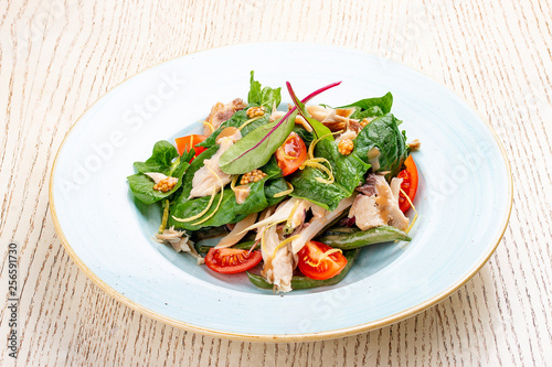 Mix salad with chicken and tomatoes. On light background