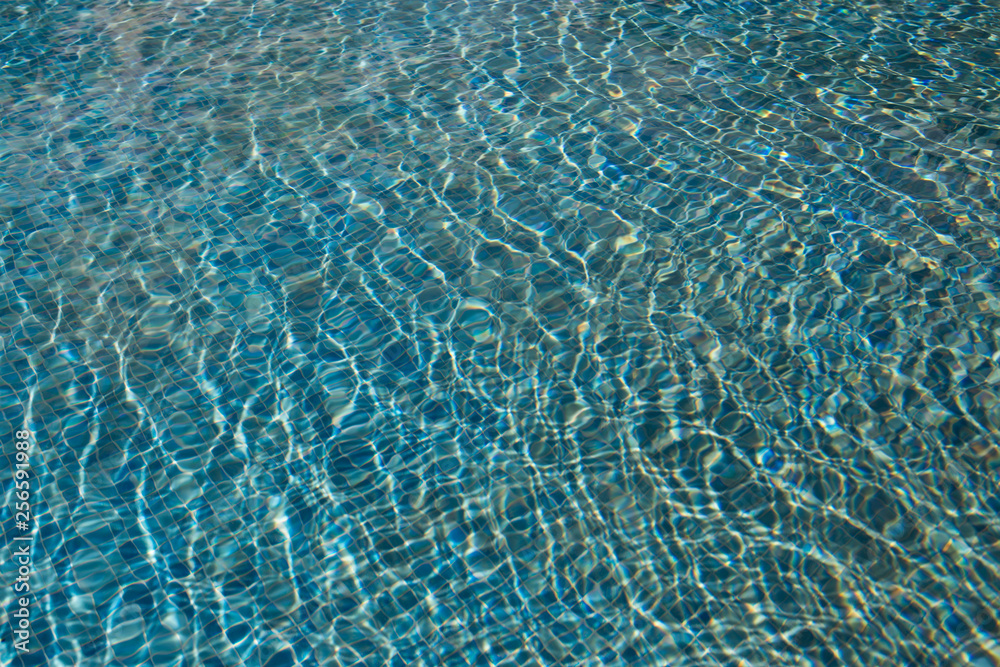 The texture of the water in the summer pool close-up The texture of the water in the summer pool close-up