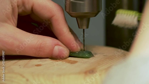 Detail of drilling hole into greenstone from New Zealand and cooling drill with water on tooth brush - SLOWMO photo