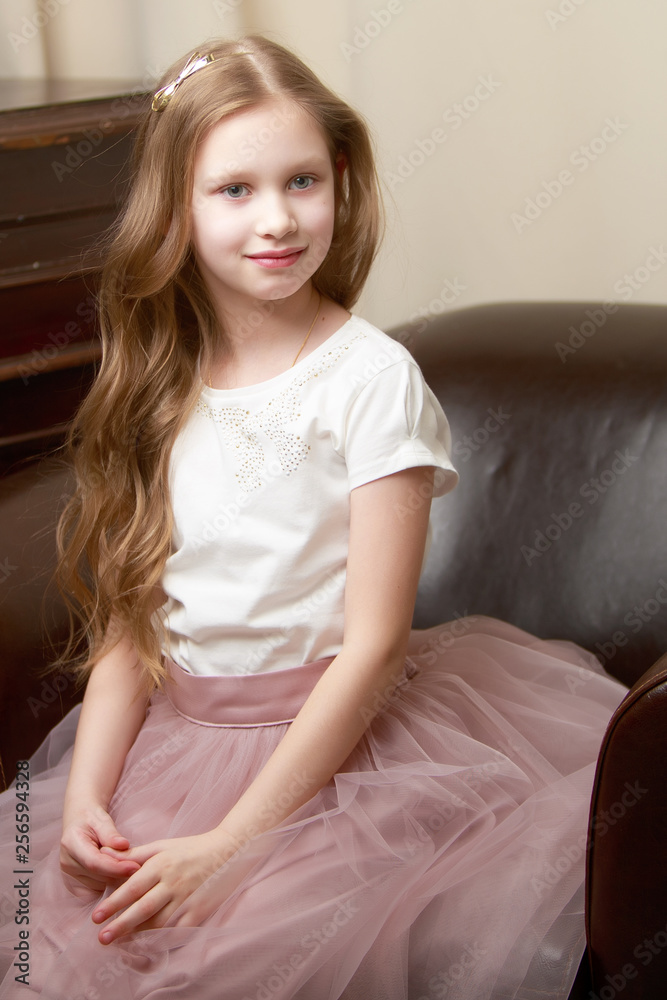 Little girl is sitting on the couch Little girl is sitting on the couch