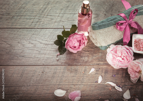 Pink English rose, lavender, organic salt and oil, spa wooden background. Rustic style. photo