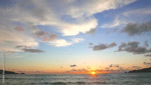 Beautiful evening on the beach with sun going down. A view of sunset and a alluring sky with fluffy clouds. photo