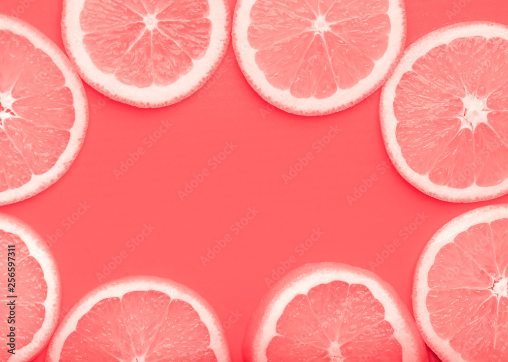 Frame from round cut slices of ripe juicy organic oranges toned in pastel pink. Top view flat lay. Vibrant color. Vitamins healthy lifestyle vegan superfoods fashion concept. Poster banner Frame from round cut slices of ripe juicy organic oranges toned in pastel pink. Top view flat lay. Vibrant color. Vitamins healthy lifestyle vegan superfoods fashion concept. Poster banner