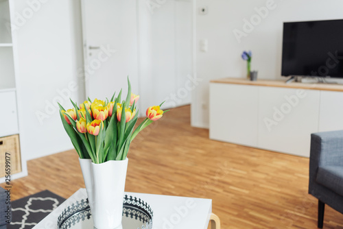 Colorful vase of yellow tulips on a table