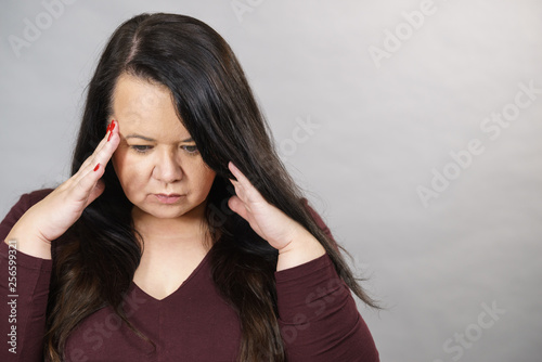 Worried woman having painfull headache photo