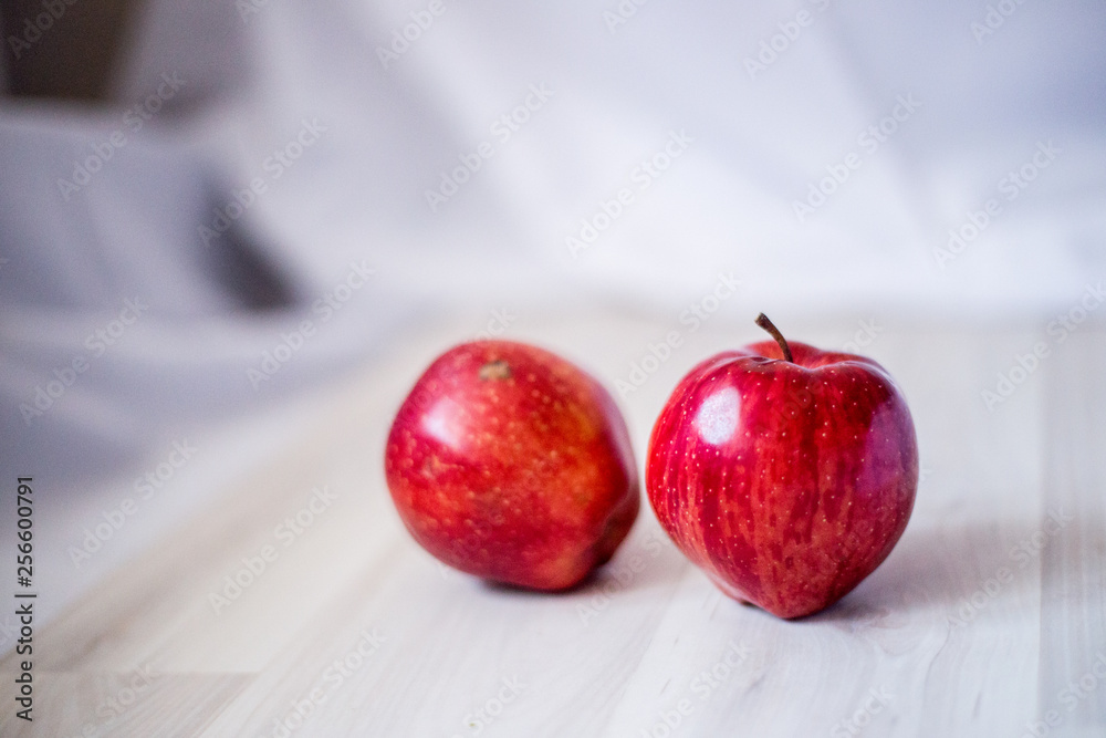 two red apples on a light background