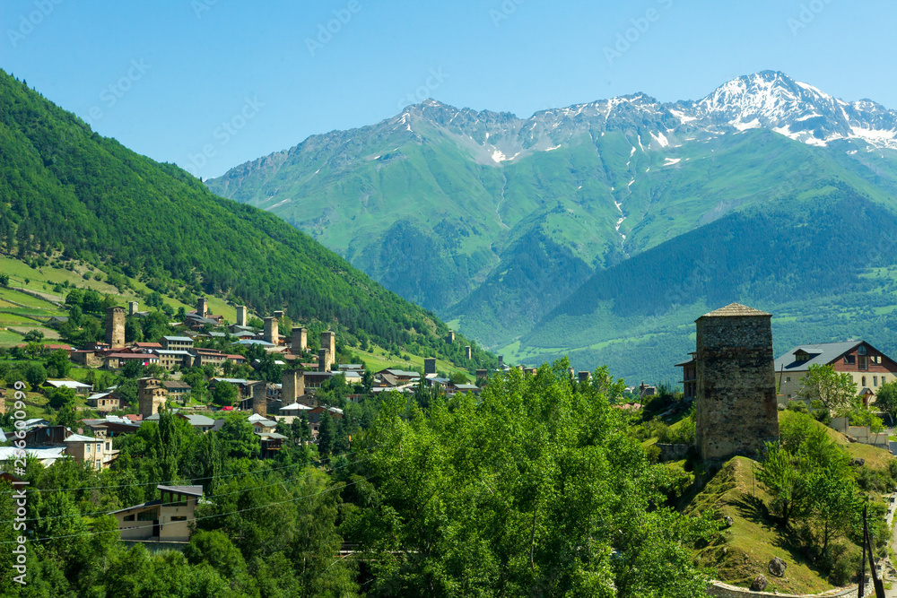 Landscape of Svaneti region, Georgia. Svan towers in Mestia mountain village, hills and high mountains on background