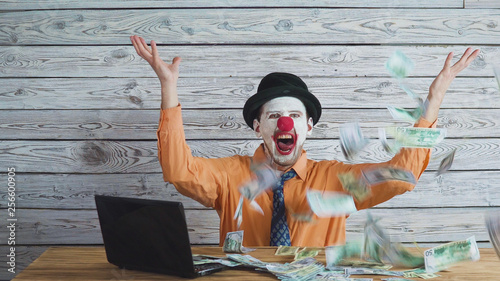 clown businessman with money in his hand. Concept on big boss with money.